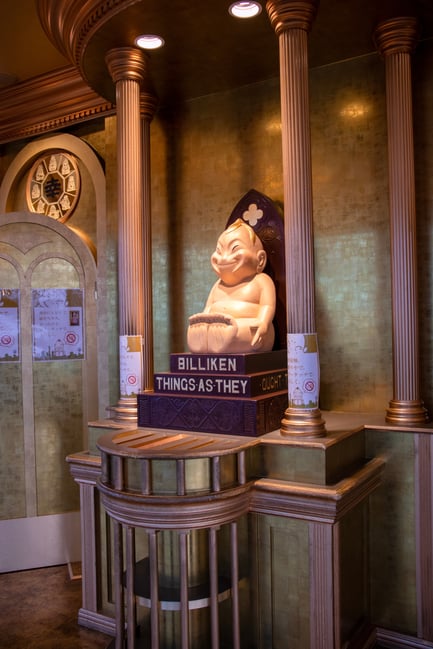 A statue of Billiken, the god of good luck, seated on a throne inside the golden-walled observatory at Tsutenkaku Tower in Osaka, Japan.