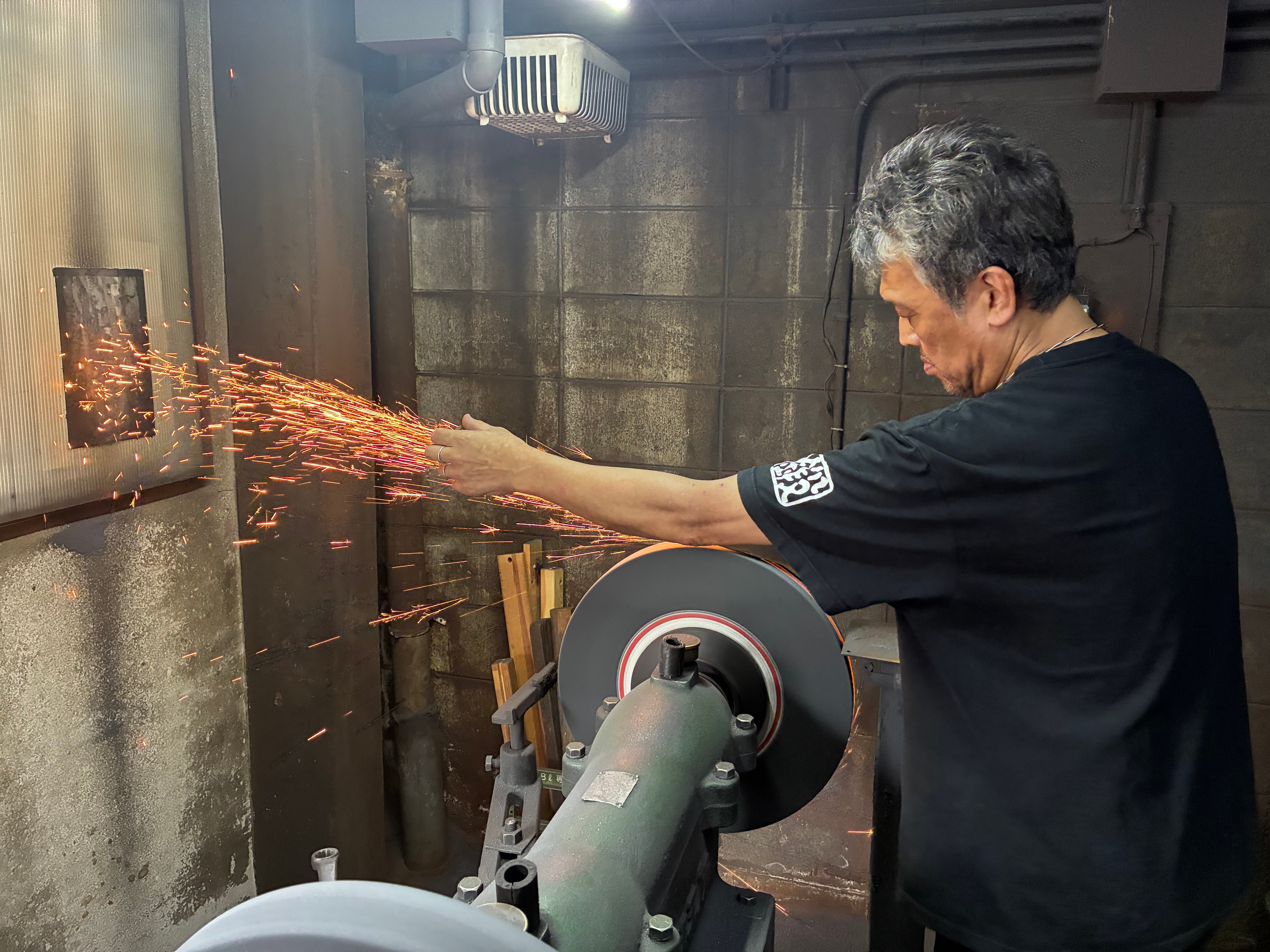 Master craftsman hand-forging traditional Japanese kitchen knives in Sakai, Osaka