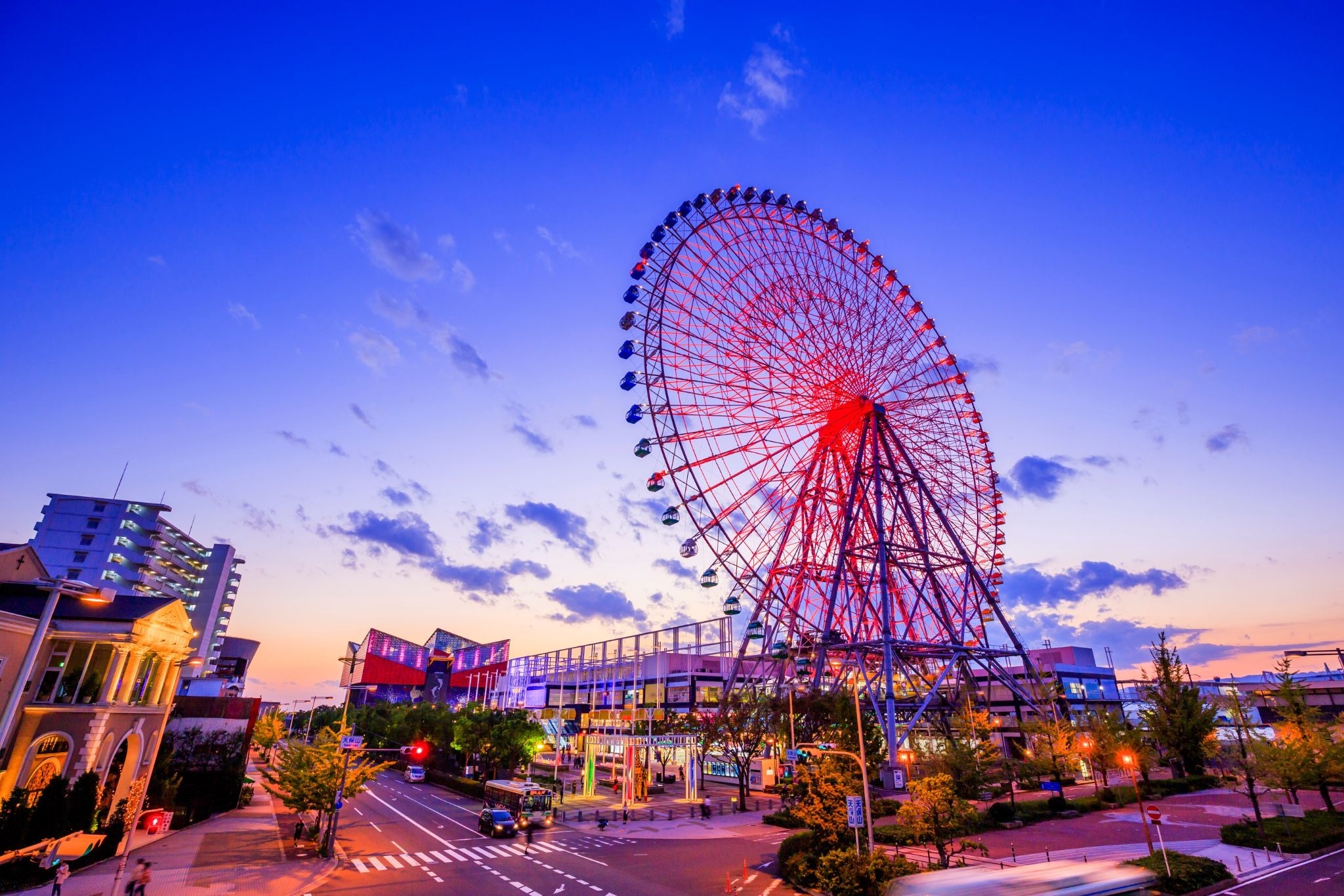 Tempozan Ferris Wheel illuminated at dusk near Osaka Aquarium Kaiyukan.