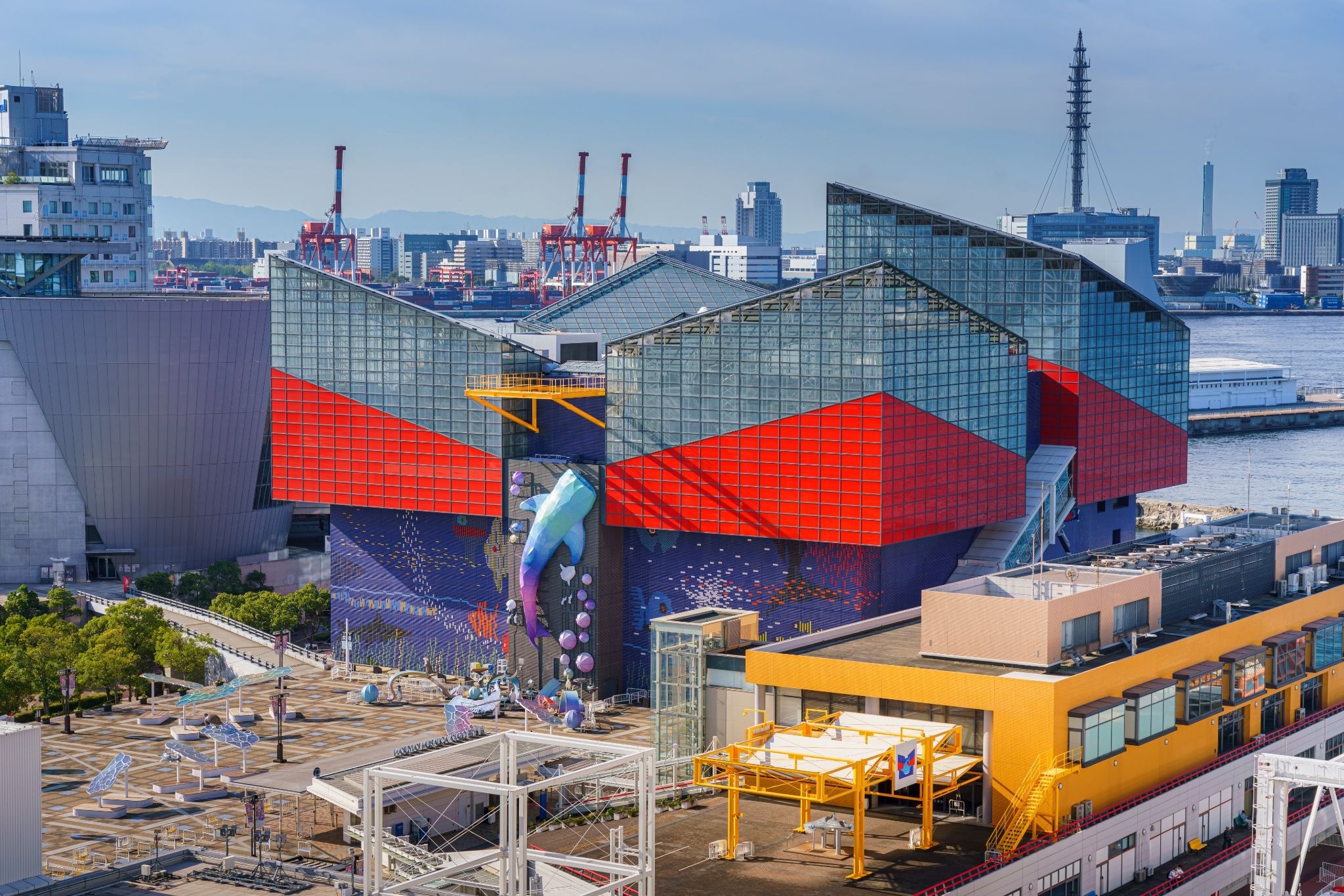 Osaka Aquarium Kaiyukan at Tempozan Harbor Village, with its distinctive red and blue exterior overlooking Osaka Bay.