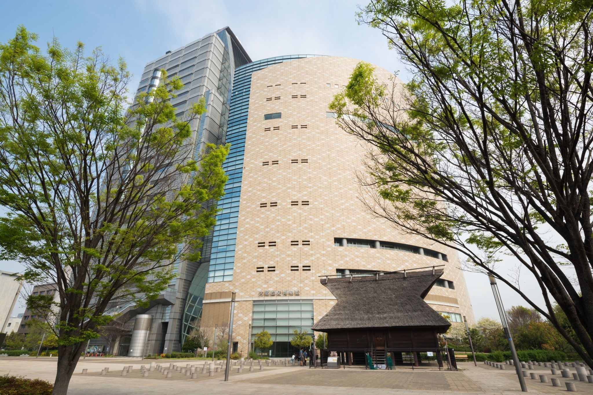 Osaka Museum of History building near Osaka Castle, framed by trees in central Osaka.